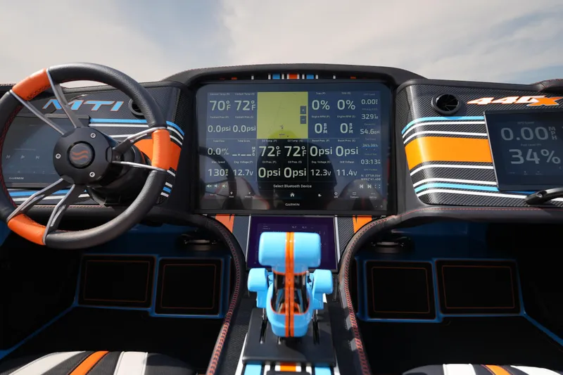 Slide: The Image of Dashboard of 2025 MTI 440X boat with digital displays and vibrant steering wheel. - 33