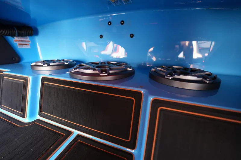 Slide: The Image of Interior of 2025 MTI 440X boat with sleek blue design and modern speakers. - 38