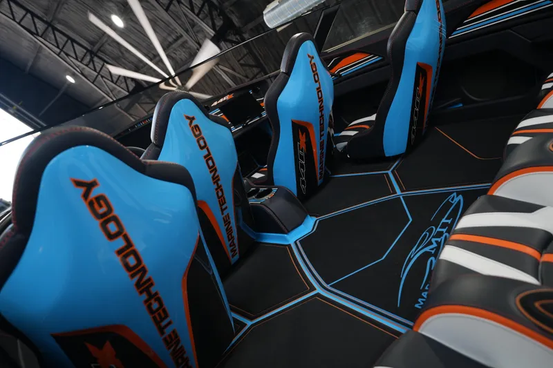 Slide: The Image of Interior of 2025 MTI 440X boat with blue and orange seating design. - 6