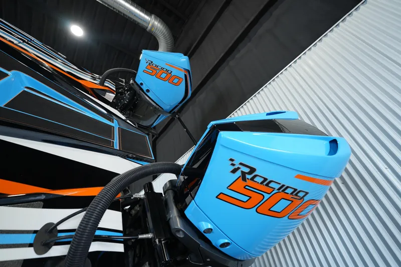 Slide: The Image of Blue Racing 500 outboard engines on MTI 440X, 2025 model, in a sleek indoor setting. - 7