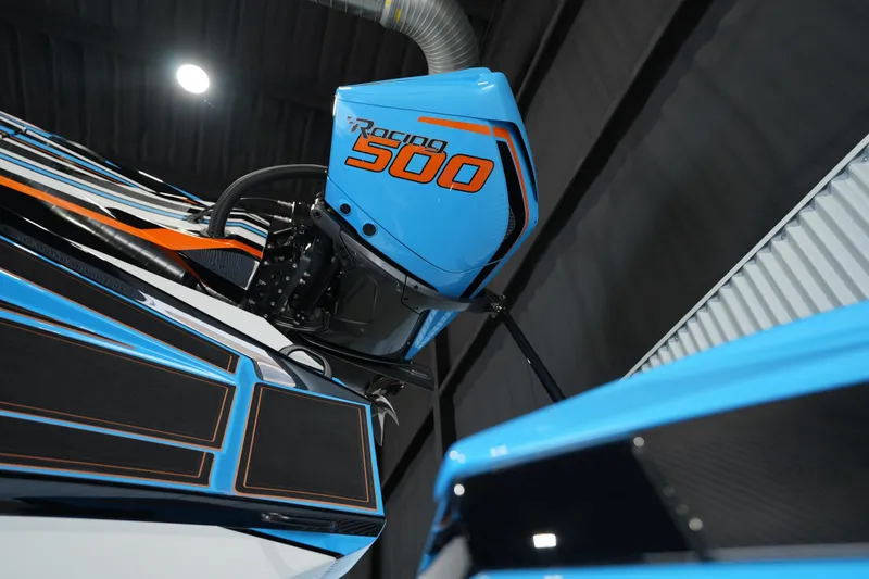 Slide: The Image of 2025 MTI 440X boat with Racing 500 engine, sleek blue and orange design. - 8