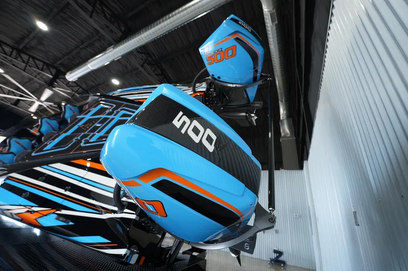Slide: The Image of Blue MTI 440X boat engines, 2025 model, with bold graphics in a modern garage setting. - 9