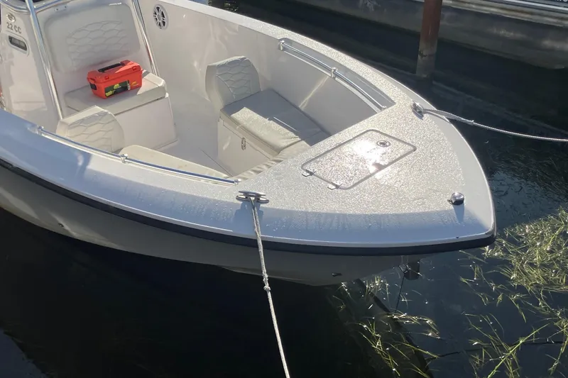 Slide: The Image of 2023 LGF 22 CC boat docked, featuring sleek design and comfortable seating. - 2
