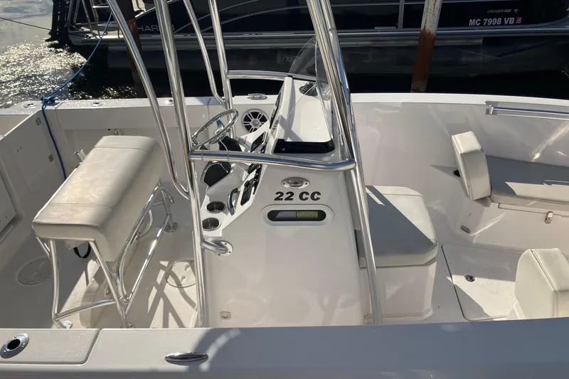 Slide: The Image of 2023 LGF 22 CC boat interior with seating and steering console. - 3