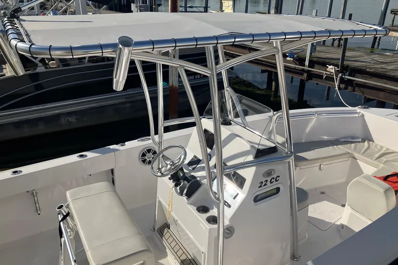 Slide: The Image of 2023 LGF 22 CC boat with T-top and console, docked at marina. - 4