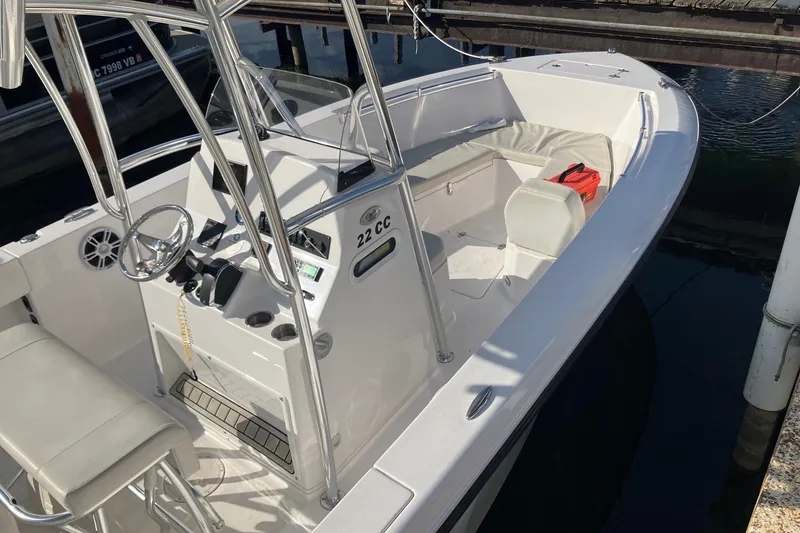 Slide: The Image of 2023 LGF 22 CC boat with sleek design, docked at marina. - 5