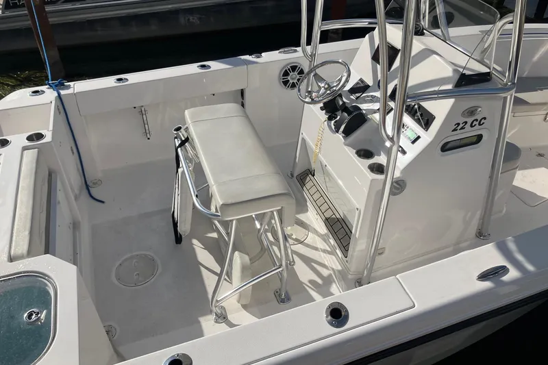 Slide: The Image of 2023 LGF 22 CC boat interior with steering console and seating. - 6