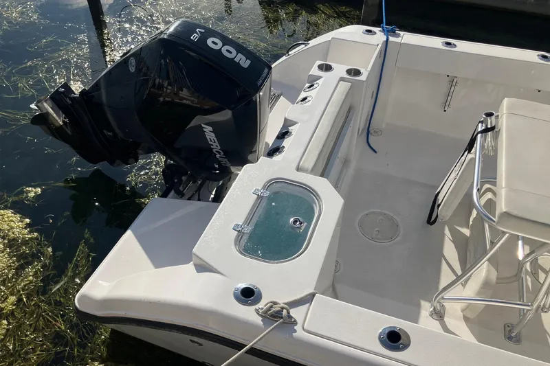 Slide: The Image of 2023 LGF 22 CC boat with Mercury outboard motor, docked on a sunny day. - 7