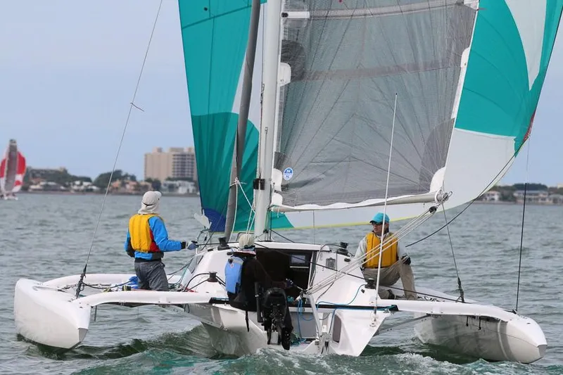 The Image of Sailors navigating a 2010 Corsair Dash 750 trimaran on open water. - 0