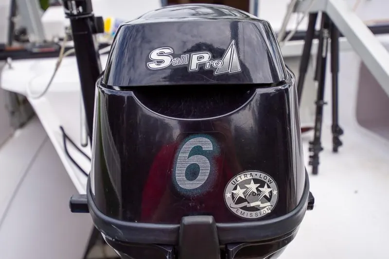 Slide: The Image of Outboard motor on a 2010 Corsair Dash 750 sailboat, featuring Sail Pro branding. - 12