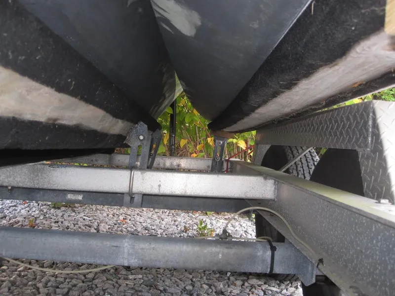 Slide: The Image of Underneath view of a 2010 Corsair Dash 750 boat on a trailer. - 13