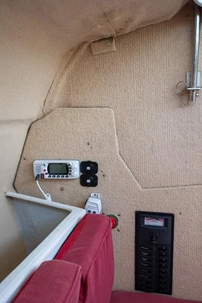 Slide: The Image of Interior of 2010 Corsair Dash 750 sailboat with navigation equipment and red seating. - 7