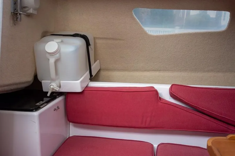 Slide: The Image of Interior of 2010 Corsair Dash 750 sailboat with red seating and water container. - 8
