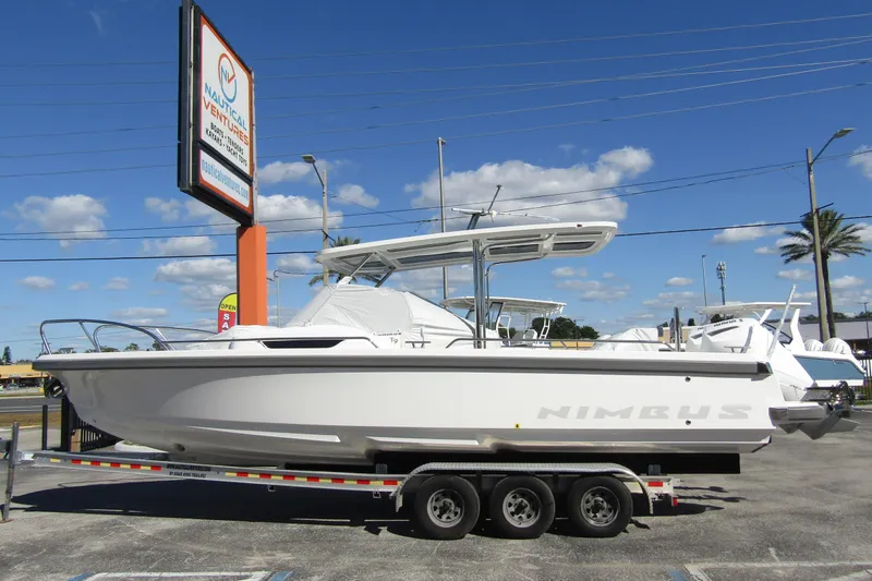Slide: The Image of 2025 Nimbus Tender 9 boat on a trailer at Nautical Ventures dealership. - 0