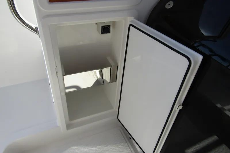 Slide: The Image of Open storage compartment on a 2025 Nimbus Tender 9 boat. - 27