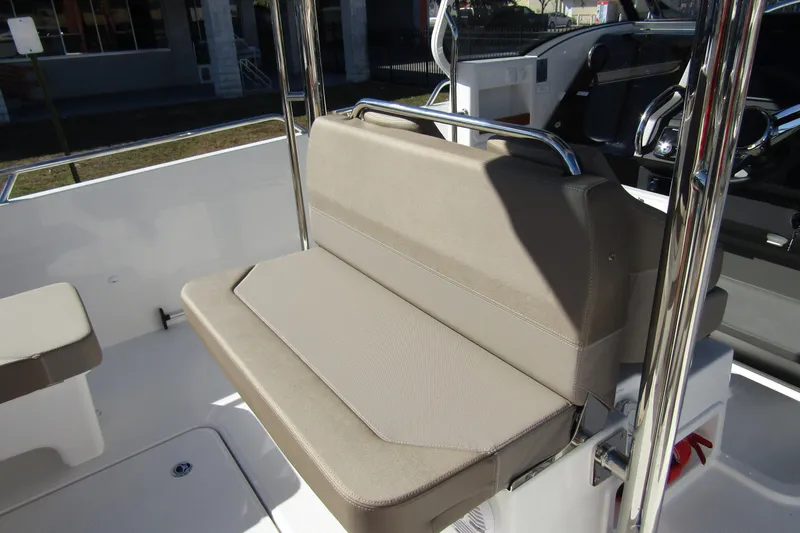 Slide: The Image of 2025 Nimbus Tender 9 boat interior with beige cushioned seating and stainless steel railings. - 41