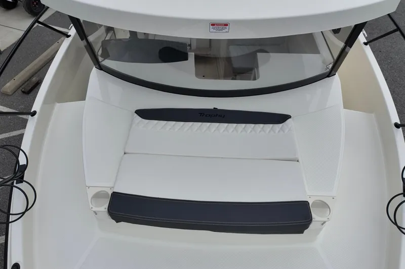 Slide: The Image of 2026 Bayliner Trophy T25 Pilothouse boat deck with cushioned seating. - 10