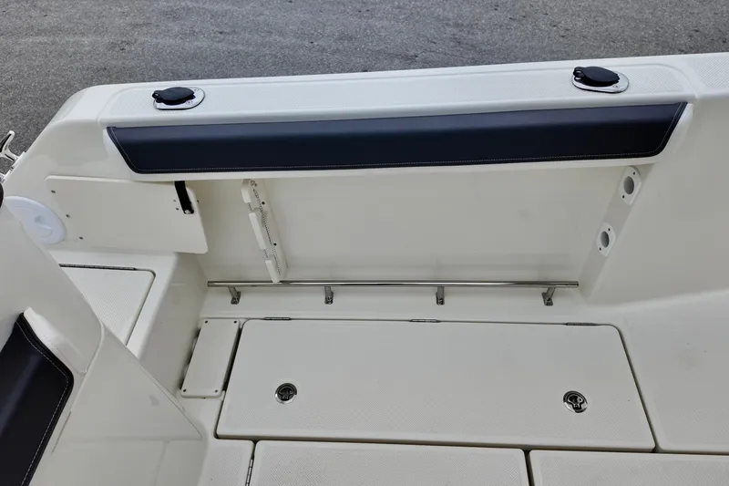 Slide: The Image of 2026 Bayliner Trophy T25 Pilothouse deck with storage compartments and rod holders. - 15