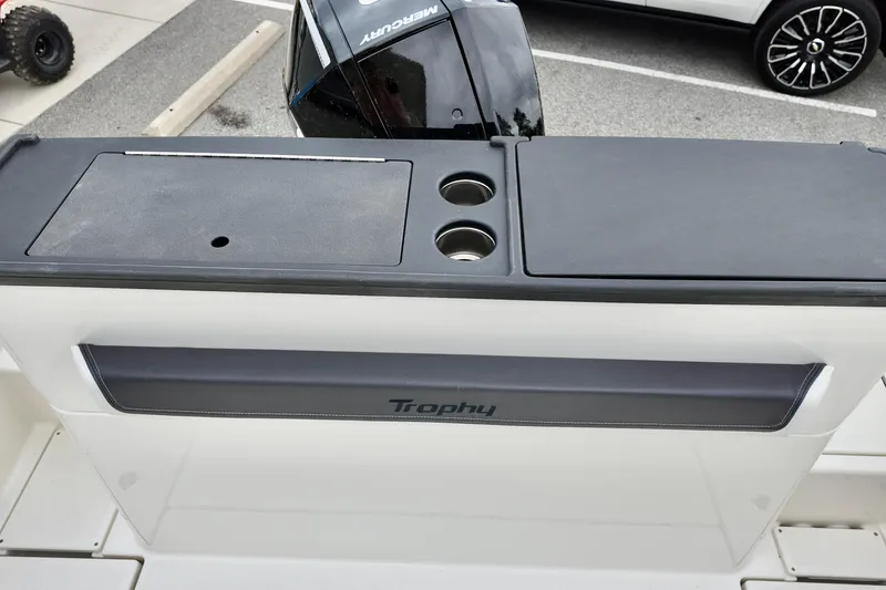 Slide: The Image of 2026 Bayliner Trophy T25 Pilothouse boat with Mercury engine, featuring sleek design and cup holders. - 17