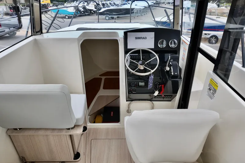 Slide: The Image of Interior of 2026 Bayliner Trophy T25 Pilothouse with steering console and seating. - 22
