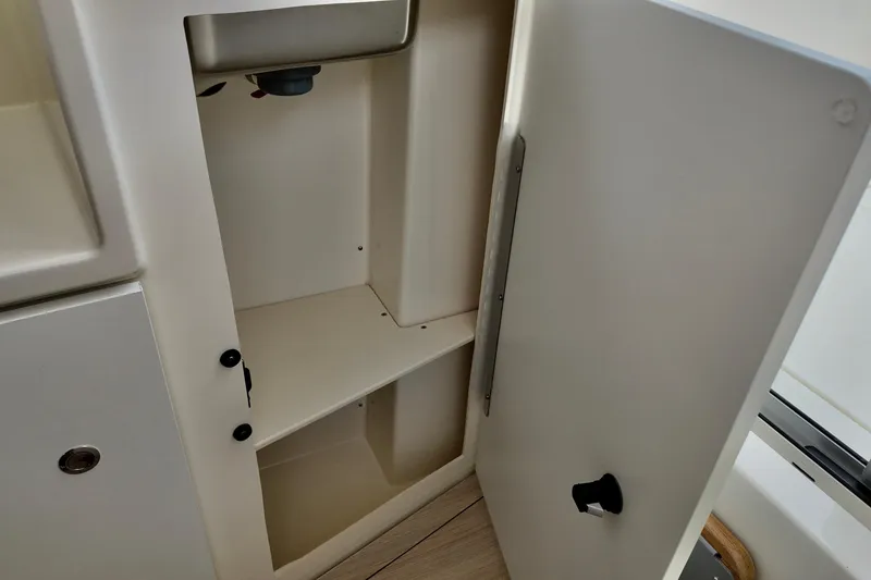 Slide: The Image of Open storage compartment in 2026 Bayliner Trophy T25 Pilothouse boat interior. - 26
