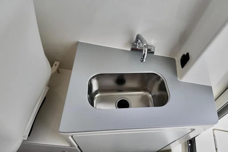 Slide: The Image of 2026 Bayliner Trophy T25 Pilothouse interior sink with modern faucet design. - 27