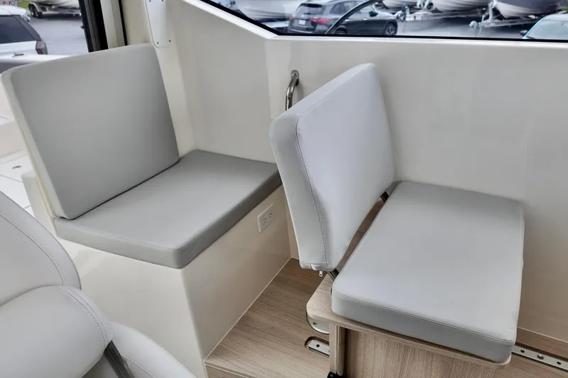Slide: The Image of Interior seating of 2026 Bayliner Trophy T25 Pilothouse boat, featuring gray cushions. - 28