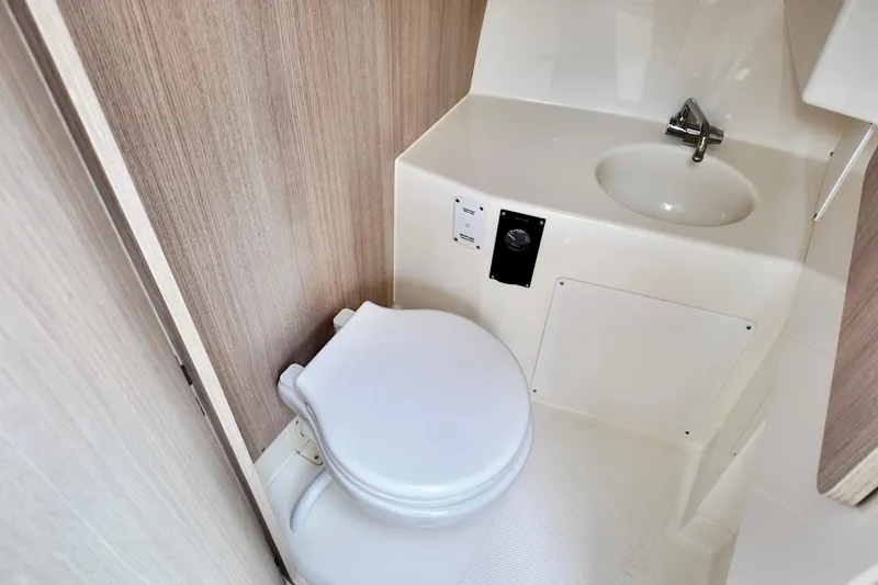 Slide: The Image of 2026 Bayliner Trophy T25 Pilothouse bathroom with compact toilet and sink. - 30