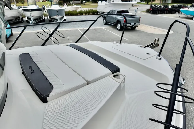 Slide: The Image of 2026 Bayliner Trophy T25 Pilothouse boat deck with seating, parked in marina. - 32