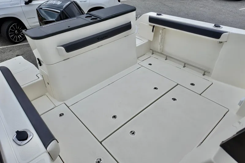 Slide: The Image of 2026 Bayliner Trophy T25 Pilothouse boat deck with storage compartments and seating. - 7