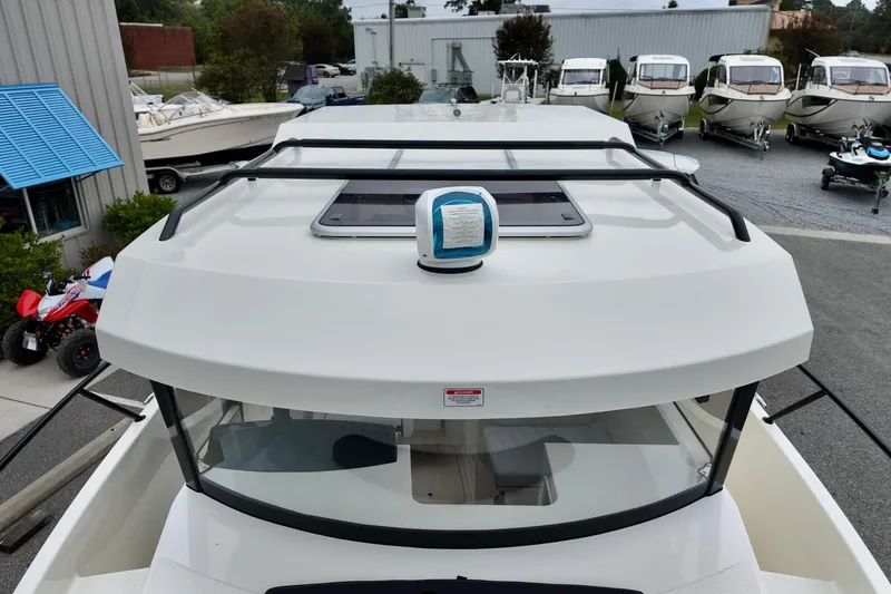 Slide: The Image of 2026 Bayliner Trophy T25 Pilothouse boat on display at a dealership. - 9