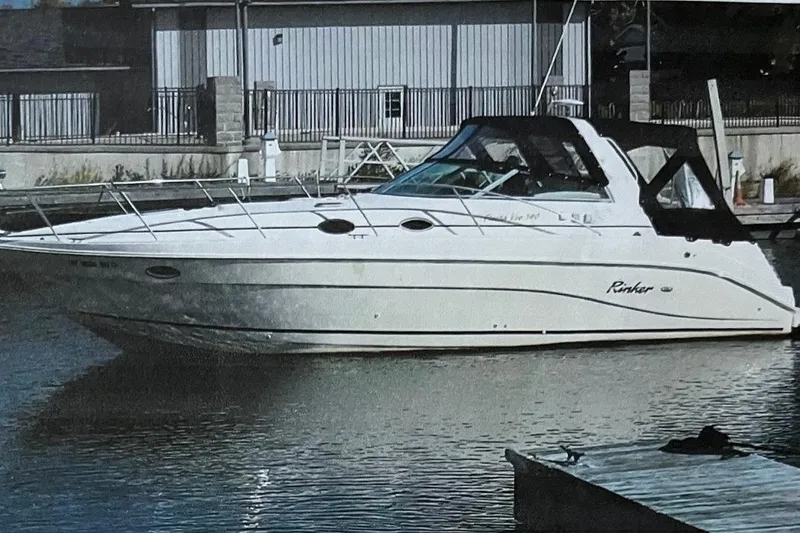 The Image of 2000 Rinker 340 Fiesta Vee boat docked in marina, side view. - 0