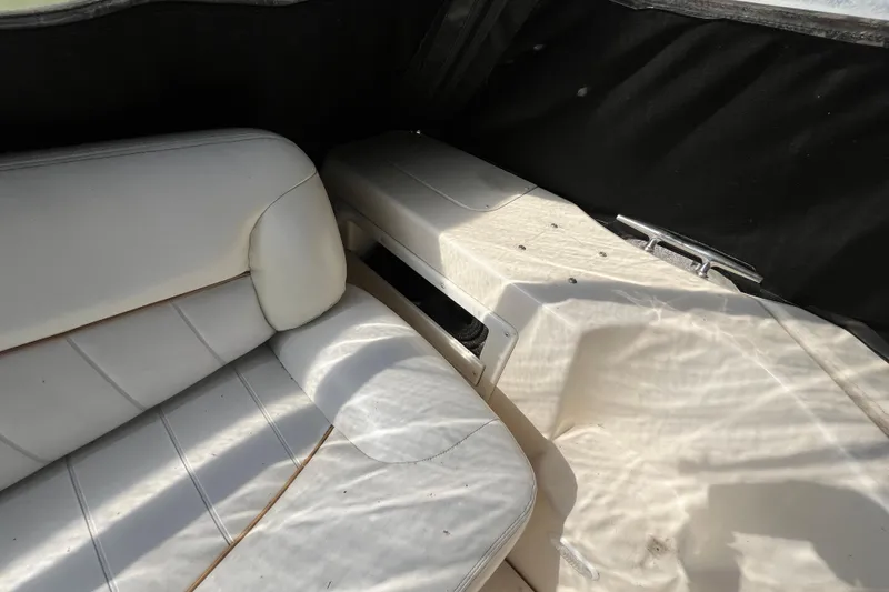 Slide: The Image of Interior of a 2000 Rinker 340 Fiesta Vee boat with white seating. - 13