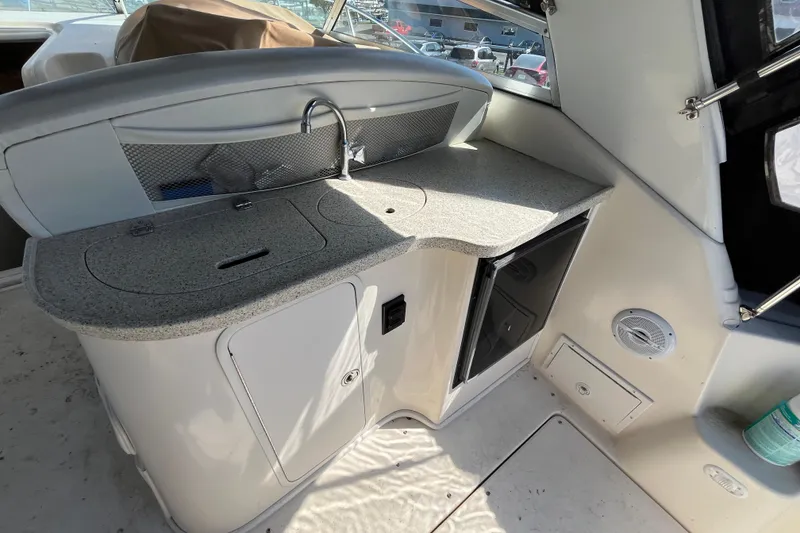 Slide: The Image of 2000 Rinker 340 Fiesta Vee boat interior with kitchenette and sink. - 14