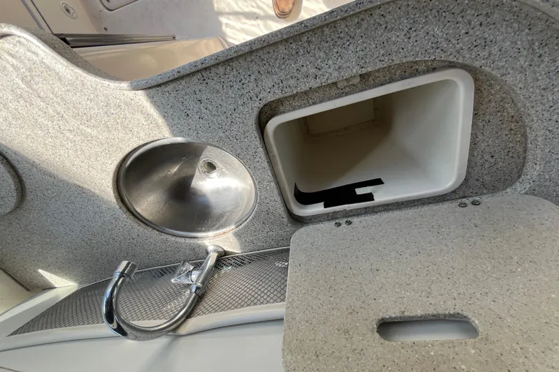 Slide: The Image of 2000 Rinker 340 Fiesta Vee boat interior with sink and storage compartment. - 15