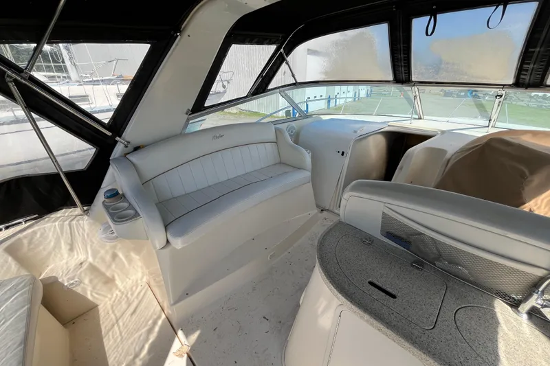 Slide: The Image of 2000 Rinker 340 Fiesta Vee boat interior with white seating and helm area. - 17