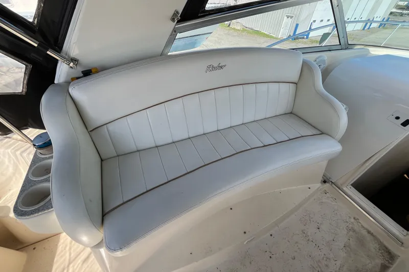 Slide: The Image of White leather seating on a 2000 Rinker 340 Fiesta Vee boat interior. - 18