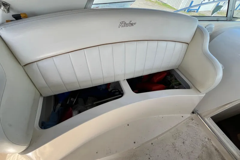 Slide: The Image of White leather seating with storage on a 2000 Rinker 340 Fiesta Vee boat. - 19