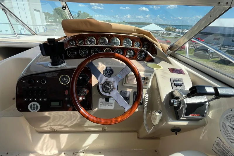 Slide: The Image of Cockpit of 2000 Rinker 340 Fiesta Vee boat with steering wheel and control panel. - 21