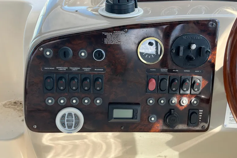 Slide: The Image of Control panel of a 2000 Rinker 340 Fiesta Vee boat with various switches and gauges. - 22