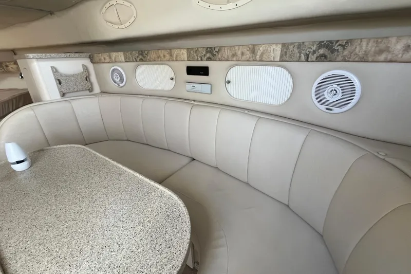 Slide: The Image of Interior of 2000 Rinker 340 Fiesta Vee boat with beige seating and table. - 30