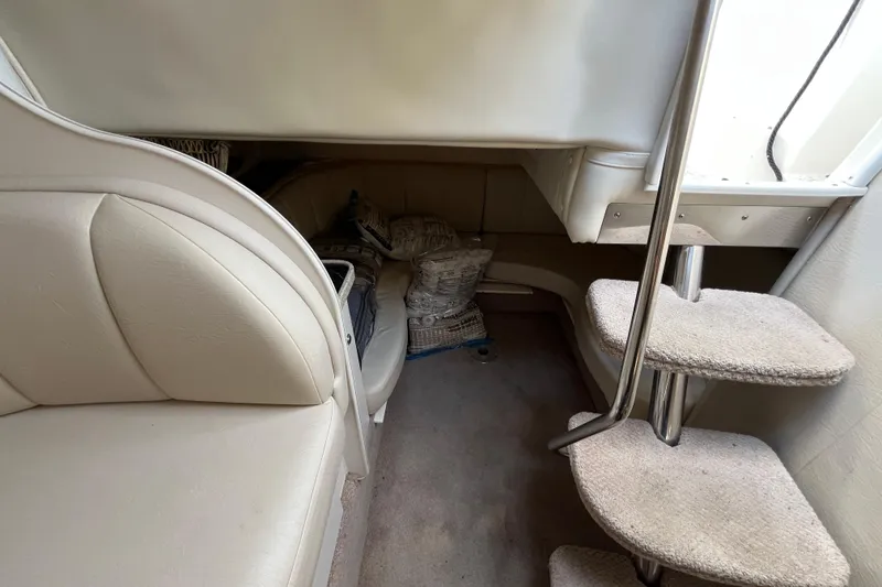 Slide: The Image of Interior of 2000 Rinker 340 Fiesta Vee boat with seating and carpeted steps. - 32