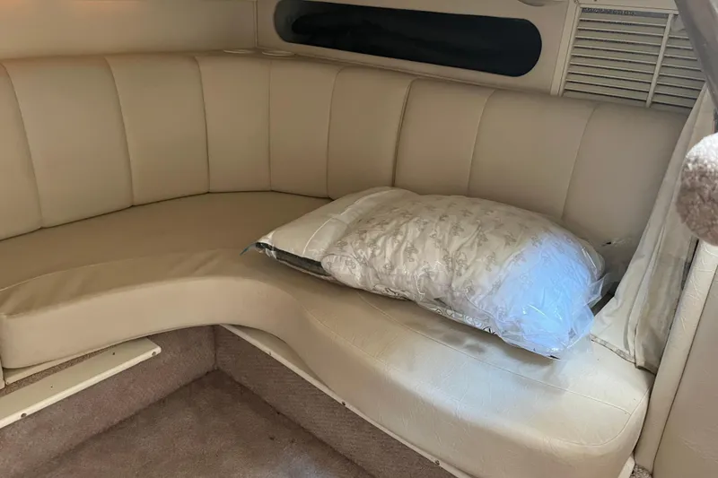 Slide: The Image of Interior of 2000 Rinker 340 Fiesta Vee with beige seating and a pillow. - 33