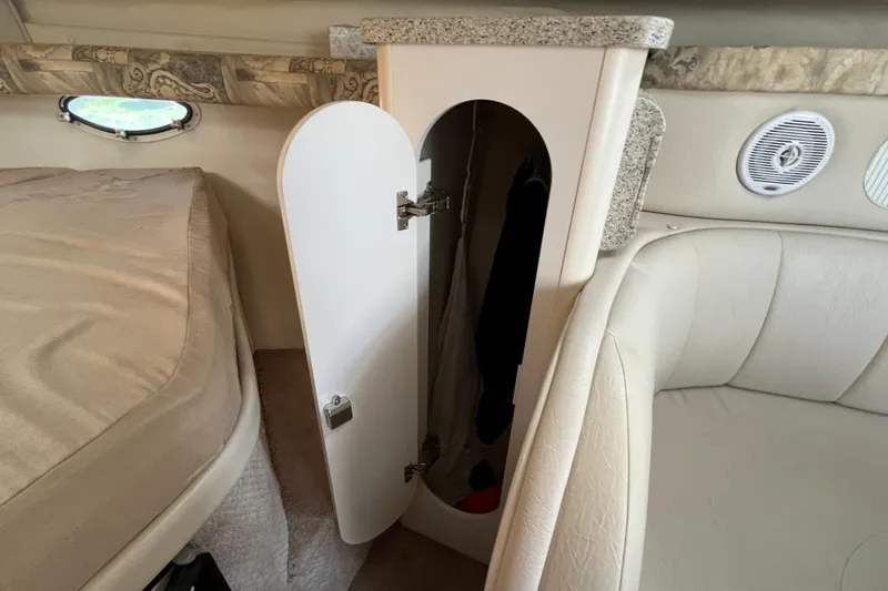 Slide: The Image of Interior of 2000 Rinker 340 Fiesta Vee boat with open storage cabinet. - 35