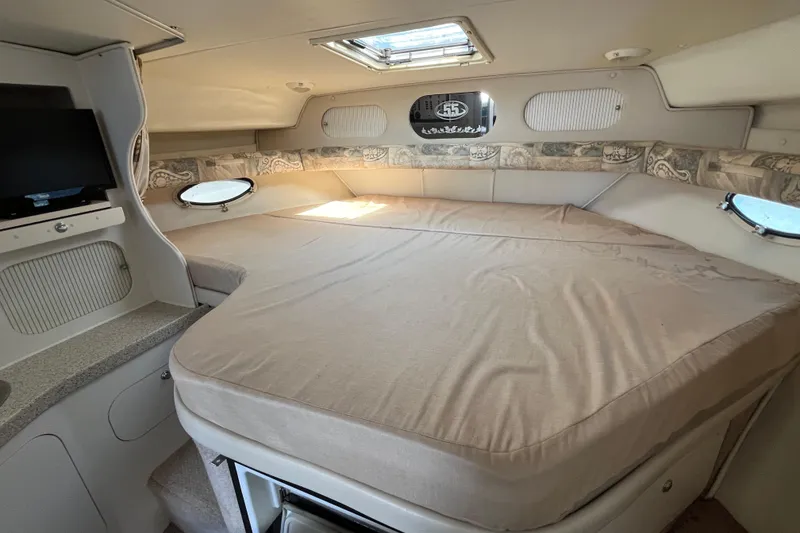 Slide: The Image of Interior cabin of 2000 Rinker 340 Fiesta Vee with bed and small TV. - 36