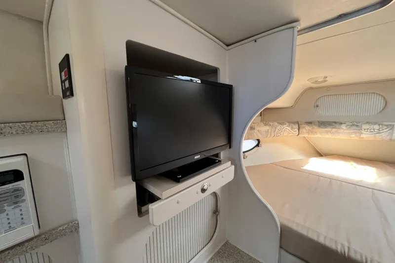 Slide: The Image of Interior of 2000 Rinker 340 Fiesta Vee with TV and cozy sleeping area. - 37