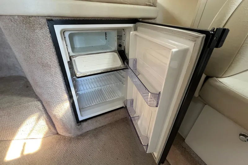 Slide: The Image of Open mini fridge inside 2000 Rinker 340 Fiesta Vee boat cabin. - 39