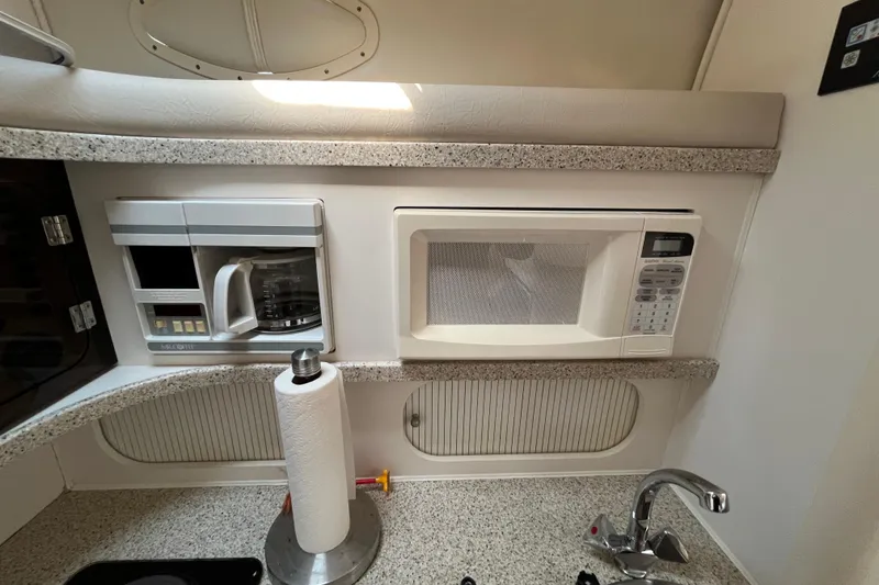 Slide: The Image of 2000 Rinker 340 Fiesta Vee kitchen with microwave, coffee maker, and paper towel holder. - 41