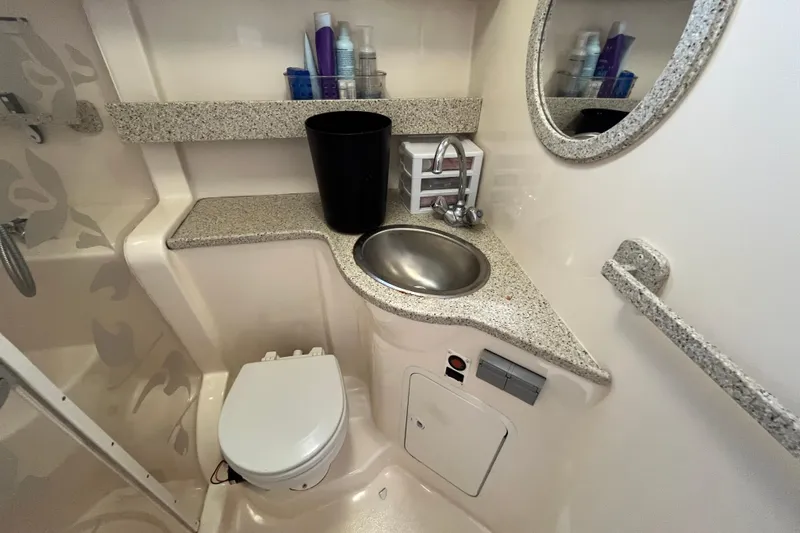 Slide: The Image of Bathroom interior of 2000 Rinker 340 Fiesta Vee boat with sink and toilet. - 47