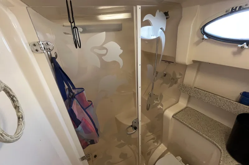 Slide: The Image of Bathroom interior of 2000 Rinker 340 Fiesta Vee boat with shower and storage. - 48